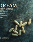 An image of Kanna Extract Company’s off-white colored Dream daily capsules on a dark granite background. Text reads ingredients of organic Sceletium tortouosum, Rest organic Kanna Extract, Baicalin, L-Theanine and Reishi. 20 Capsules included and Dream Kanna Dailies are a available for sale bulk and wholesale.