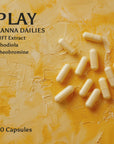 An image of Kanna Extract Company’s cream colored PLAY Kanna Daily capsules on a yellow stone background. Text reads 20 Capsules made from organic Sceletium tortuosum. Ingredients include LIFT Kanna Extract, Rhodiola and Theobromine. Play Kanna Dailies are available for purchase in bulk, retail and wholesale.